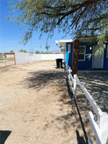 a view of road yard with wooden fence