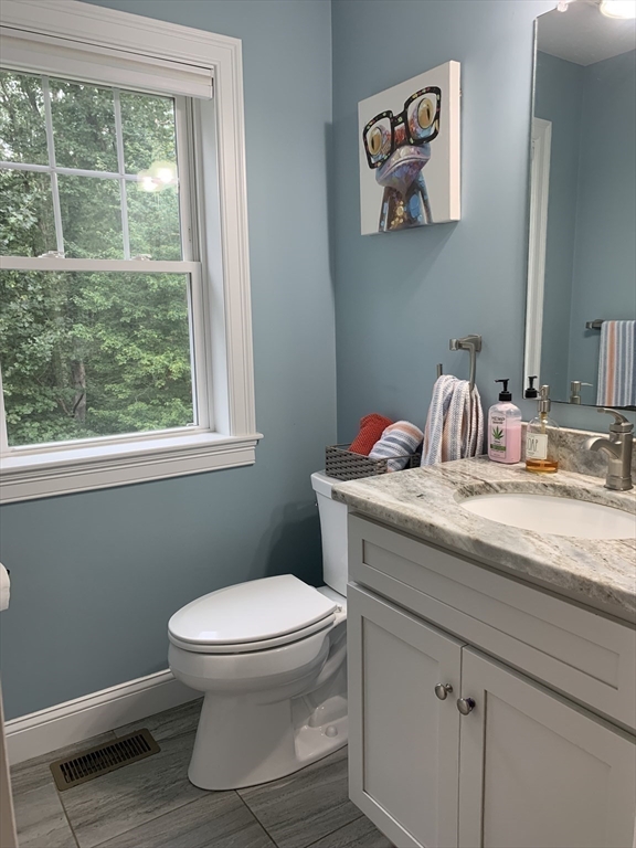 39 Davidson Road Charlton, MA 01507 - Photo 13 of 42 a bathroom with a granite countertop toilet a sink and a window