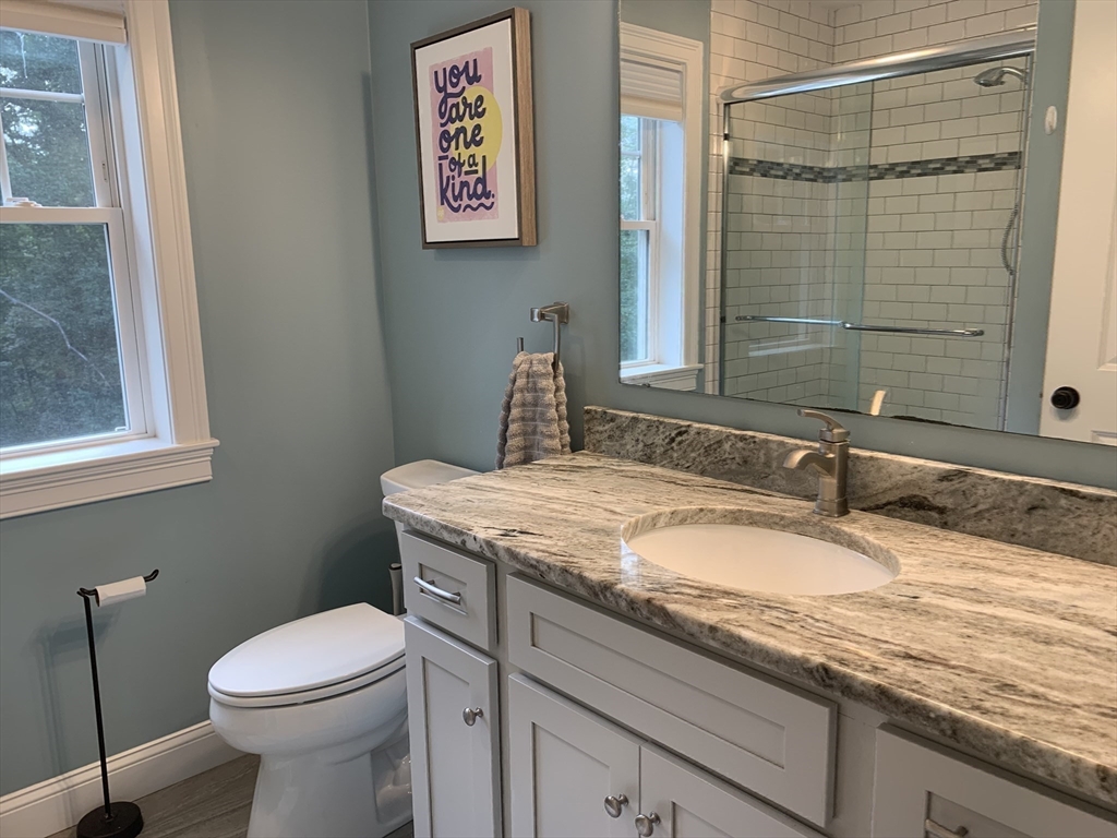 39 Davidson Road Charlton, MA 01507 - Photo 21 of 42 a bathroom with a granite countertop sink a toilet and a mirror