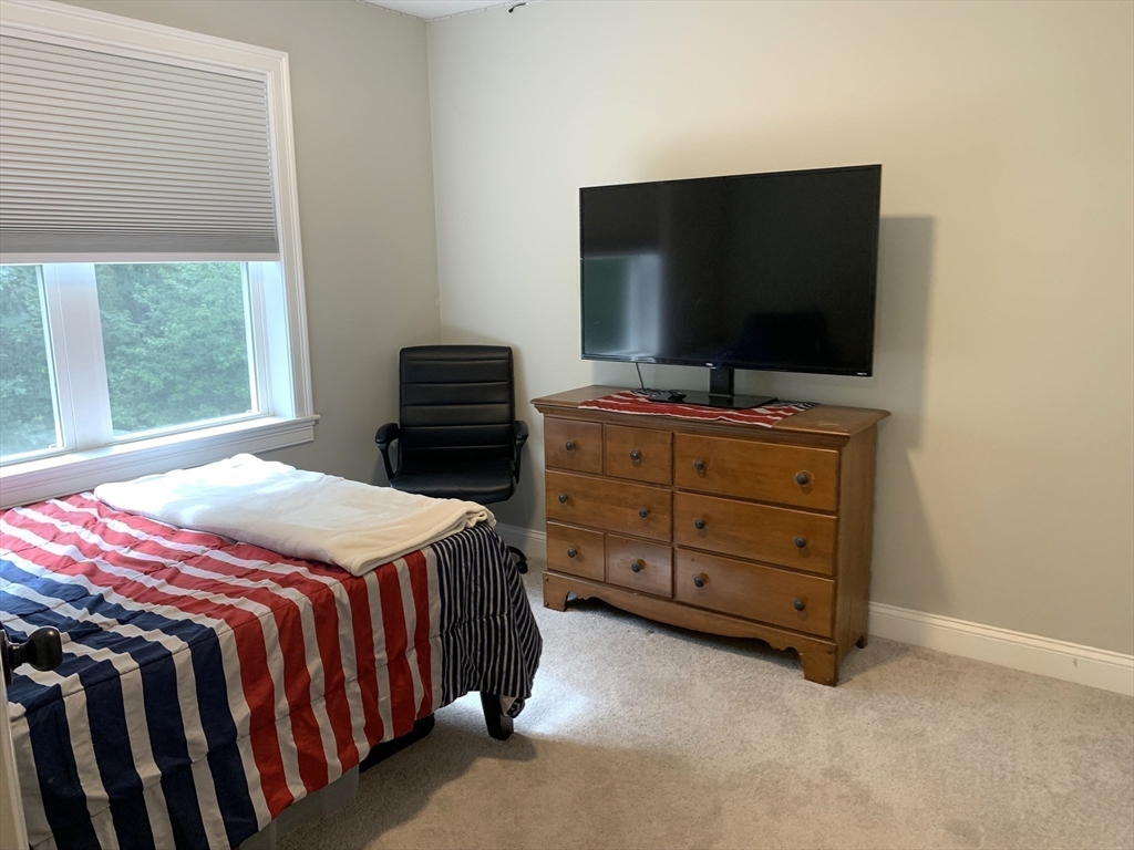 39 Davidson Road Charlton, MA 01507 - Photo 23 of 42 a bedroom with a bed and a flat screen tv