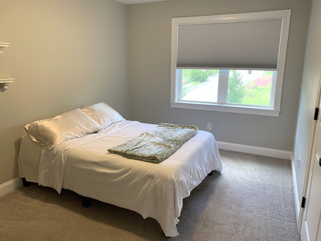 39 Davidson Road Charlton, MA 01507 - Photo 25 of 42 a bed sitting in a bedroom next to a window