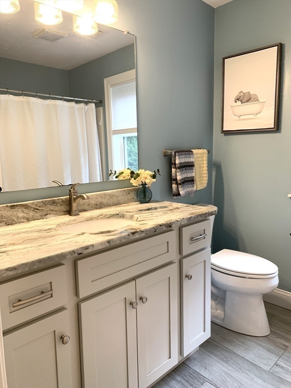 39 Davidson Road Charlton, MA 01507 - Photo 27 of 42 a bathroom with a granite countertop toilet sink and mirror