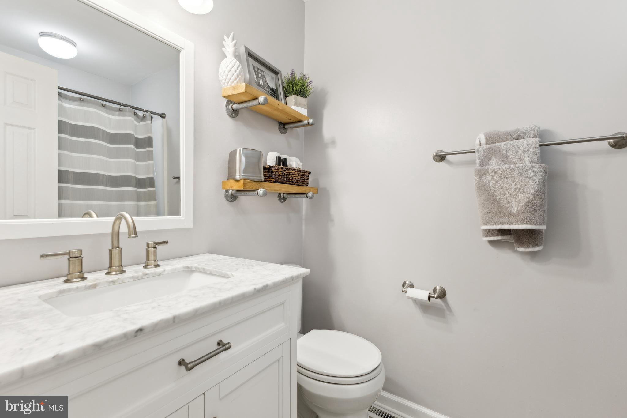 7461 Robin Road La Plata, MD 20646 - Photo 11 of 30 a bathroom with a sink a toilet and mirror