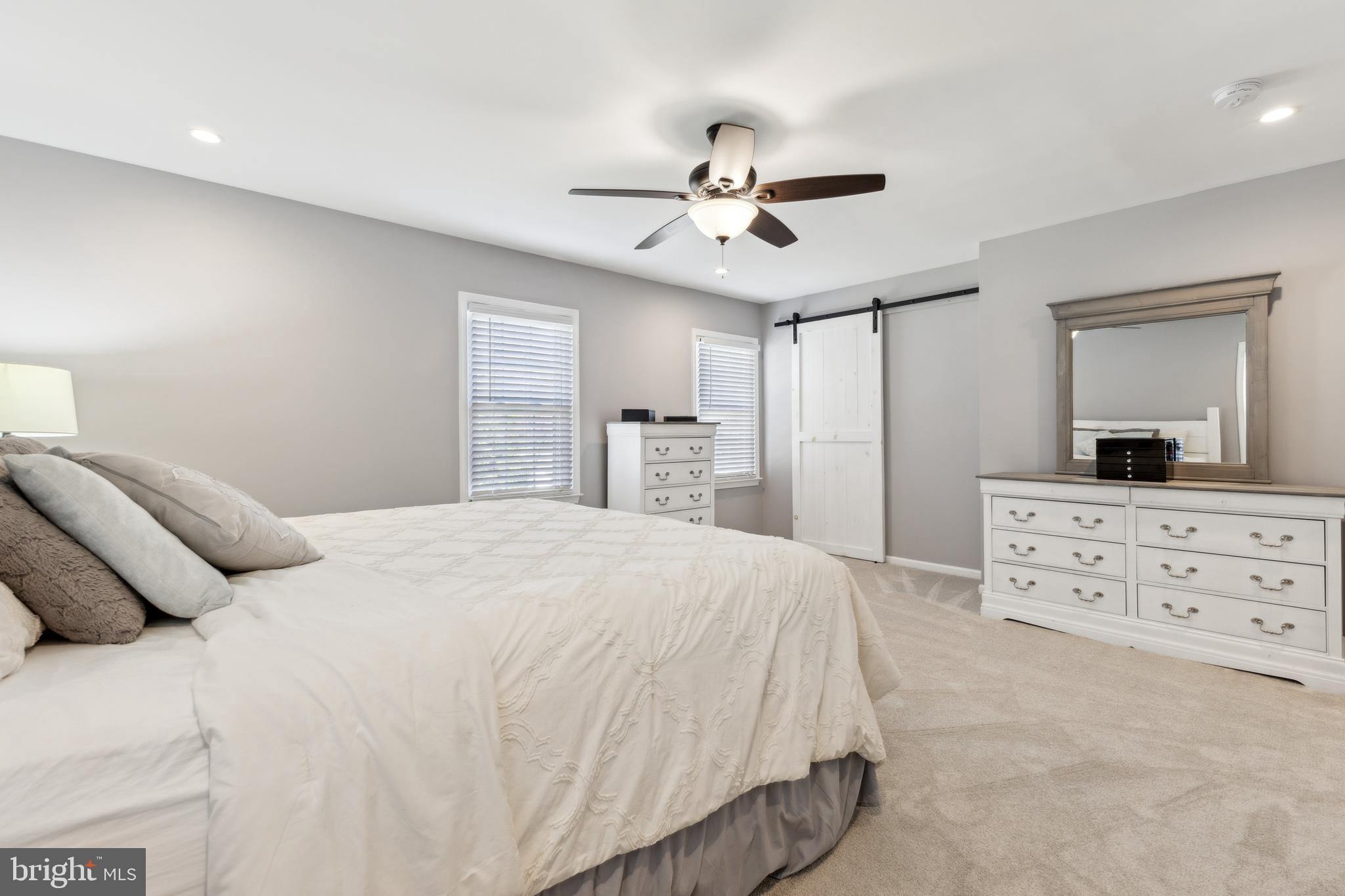 7461 Robin Road La Plata, MD 20646 - Photo 13 of 30 a bedroom with a large bed and a chandelier