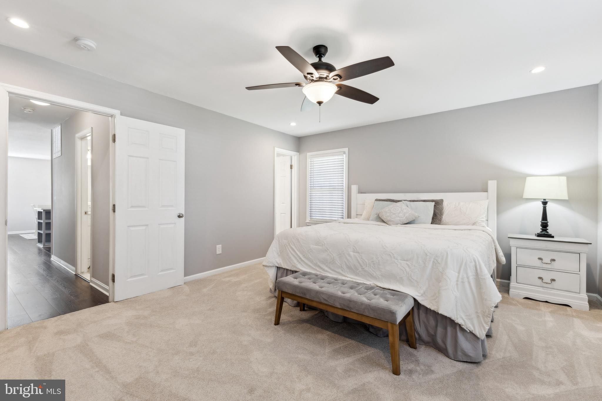 7461 Robin Road La Plata, MD 20646 - Photo 14 of 30 a bedroom with a bed and a chandelier