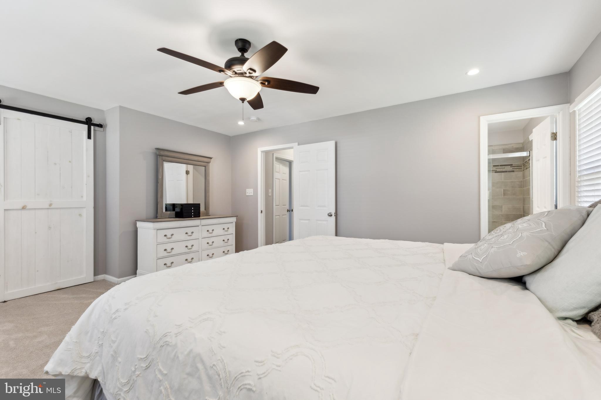 7461 Robin Road La Plata, MD 20646 - Photo 15 of 30 a bedroom with a large bed and a chandelier