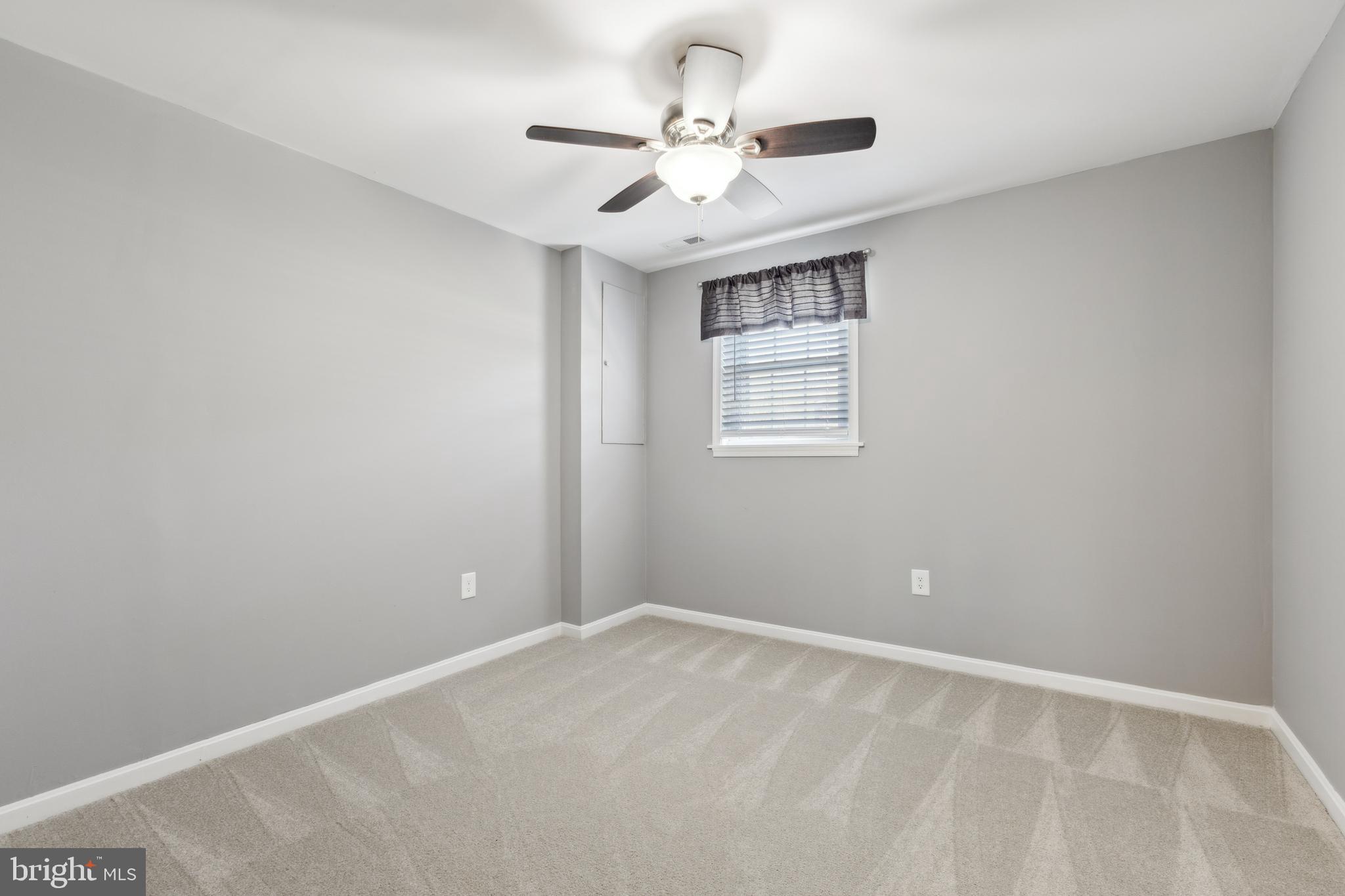 7461 Robin Road La Plata, MD 20646 - Photo 24 of 30 an empty room with windows and ceiling fan
