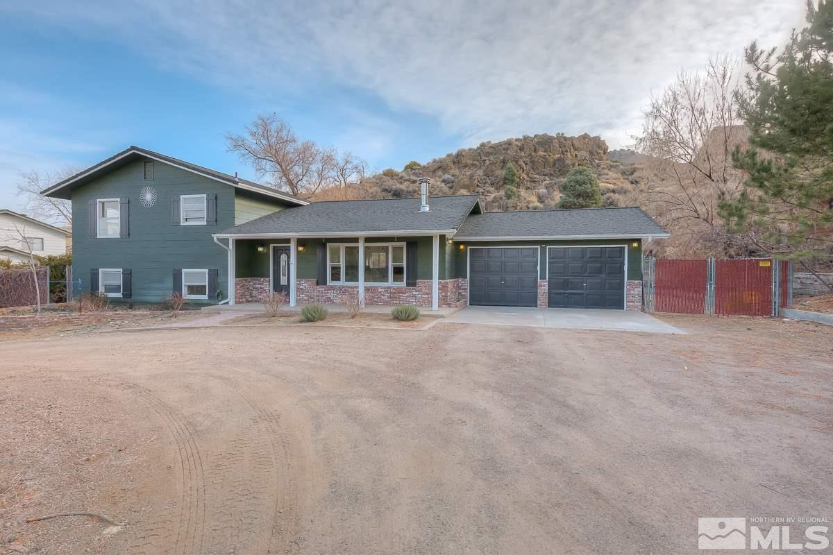 13830 Virginia Foothills Drive Reno, NV 89521 - Photo 1 of 25 a front view of a house with a yard and garage