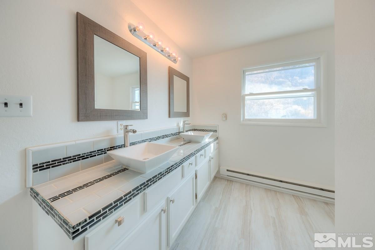 13830 Virginia Foothills Drive Reno, NV 89521 - Photo 12 of 25 a bathroom with a sink and a mirror