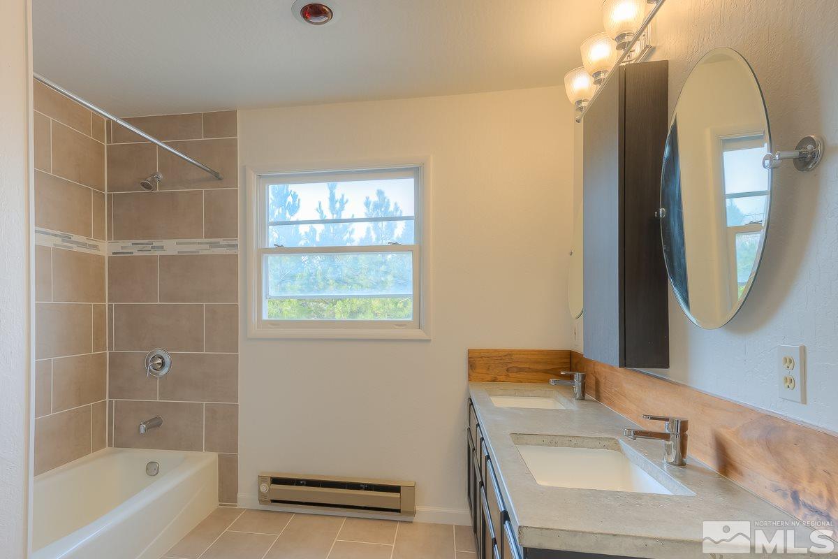 13830 Virginia Foothills Drive Reno, NV 89521 - Photo 16 of 25 a bathroom with a sink and a mirror