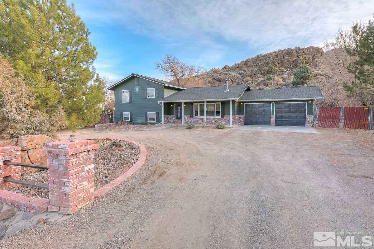 13830 Virginia Foothills Drive Reno, NV 89521 - Photo 3 of 25 a front view of a house with a yard and potted plants