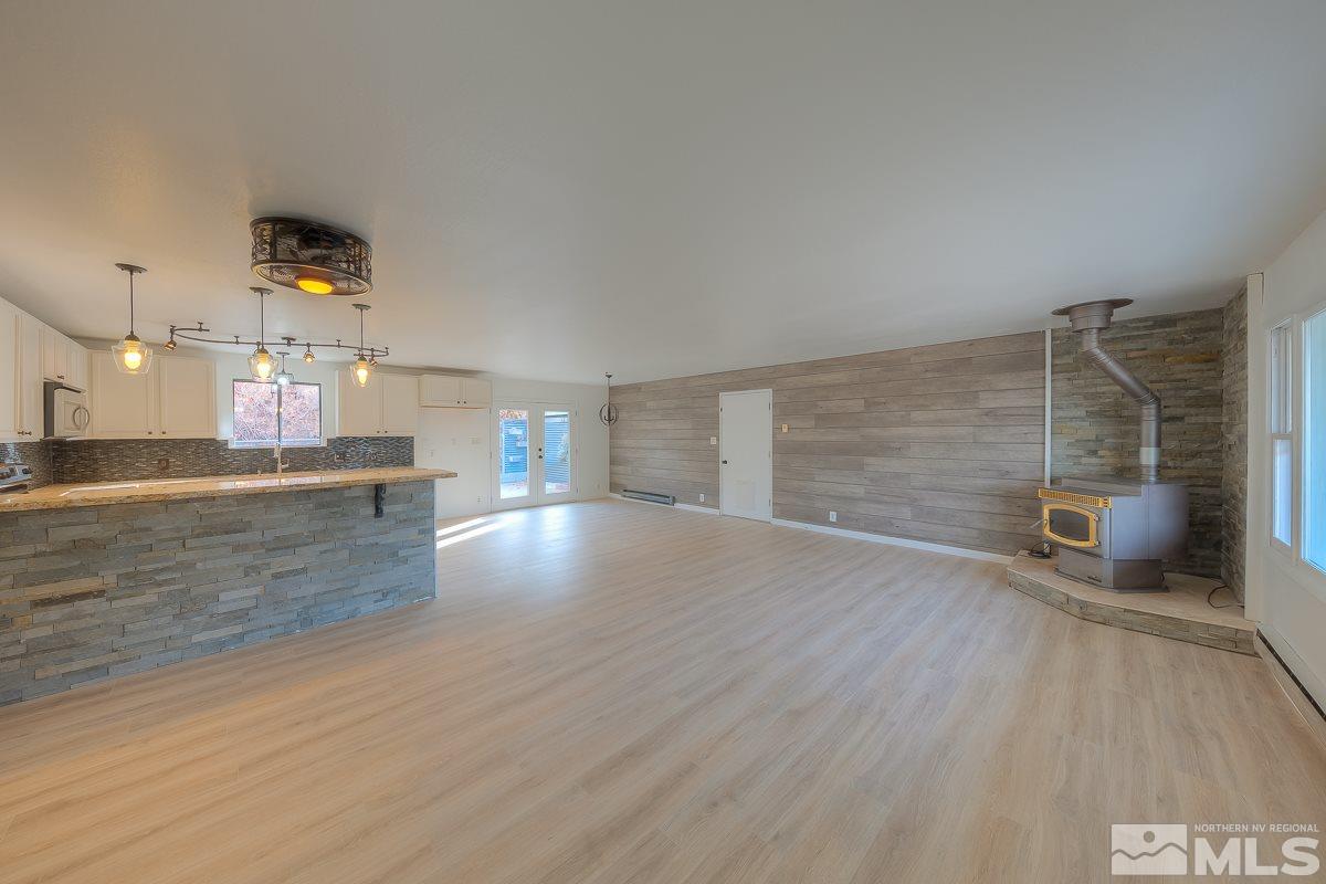13830 Virginia Foothills Drive Reno, NV 89521 - Photo 4 of 25 an empty room with wooden floor and windows