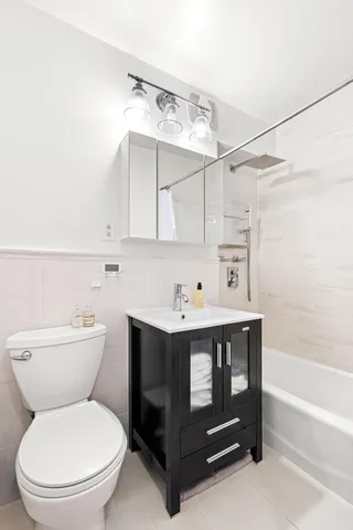 a bathroom with a sink a toilet and bathtub