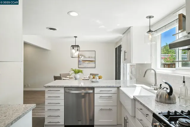 a bathroom with a granite countertop sink a mirror and shower