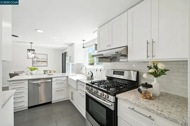 a kitchen with a sink stove and cabinets