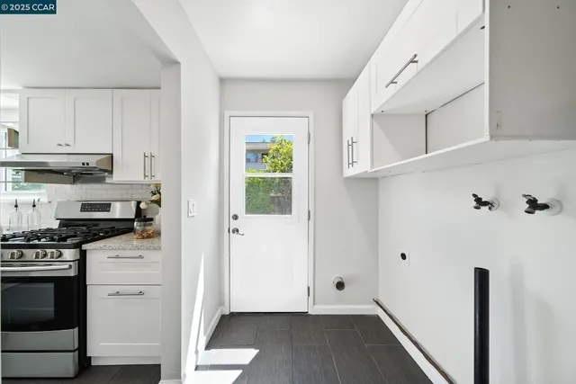 a kitchen with cabinets and wooden floor