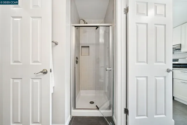 a bathroom with a glass shower door