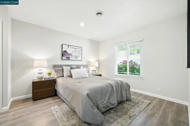 a bedroom with a large bed and a window