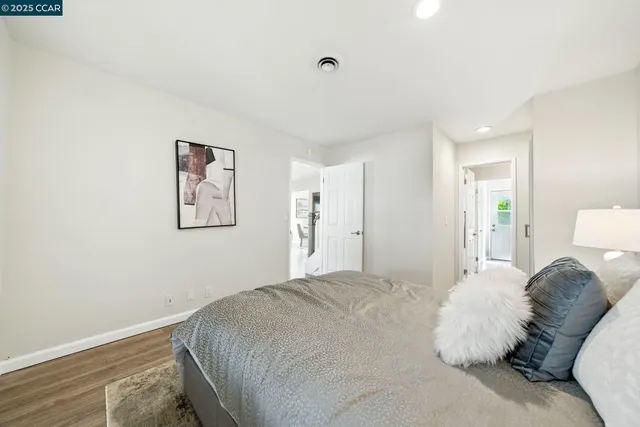 a bedroom with a bed and a painting