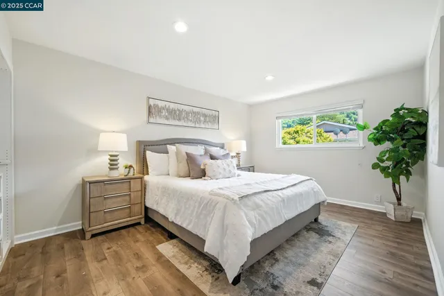 a bedroom with a bed and a potted plant