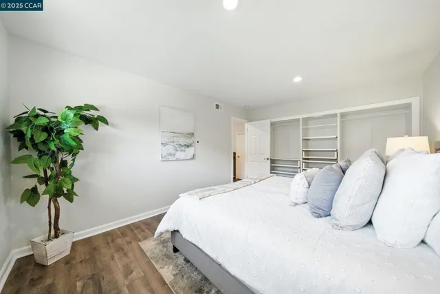a bedroom with a bed and a potted plant