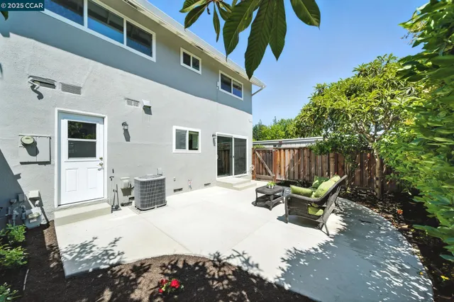a view of backyard with a chair and tables