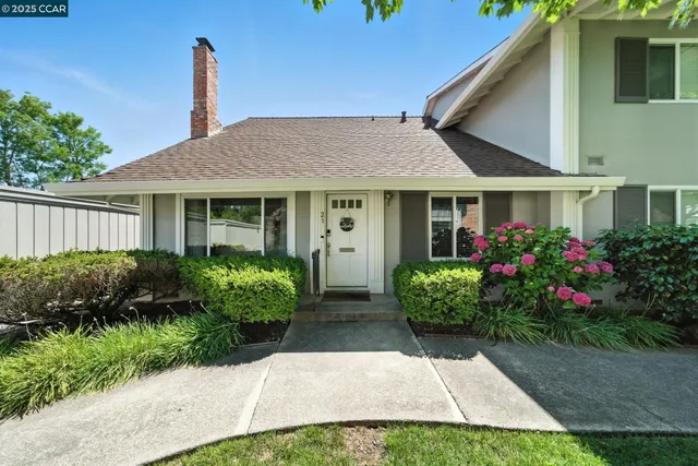 a front view of a house with garden
