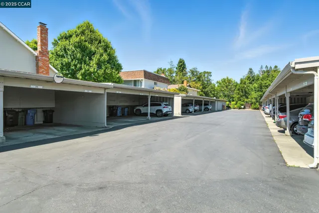a view of a house with a yard and potted plants