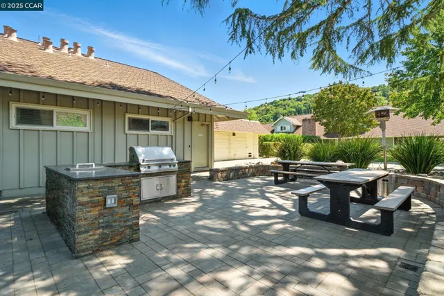 a view of a patio with table and chairs and potted plants