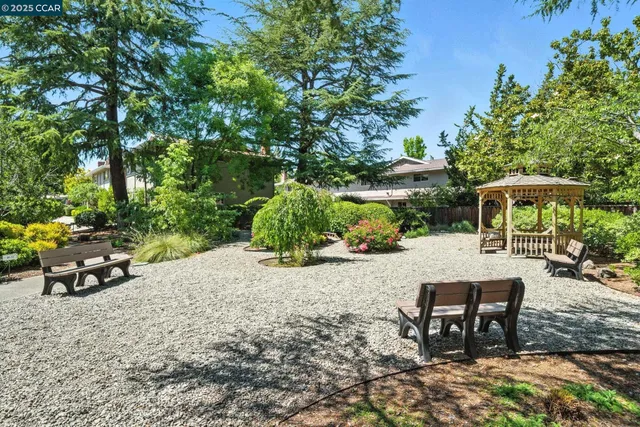 a view of a backyard with sitting area