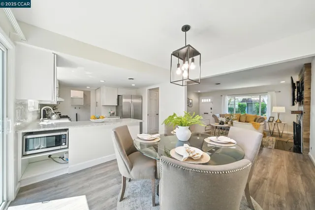a living room with kitchen island furniture and a chandelier