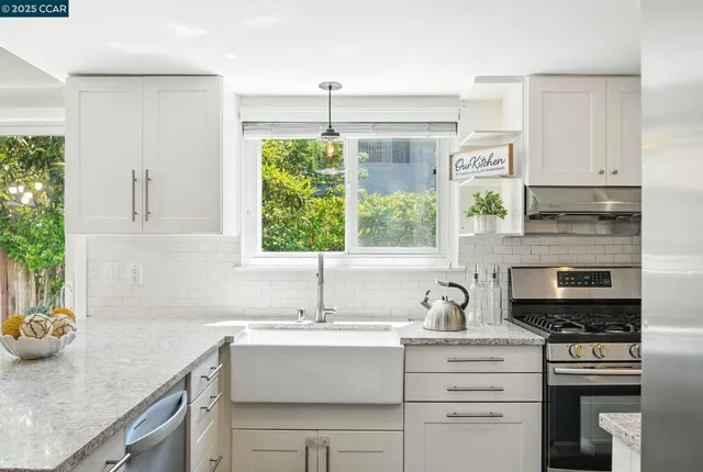 a kitchen with a sink stove and cabinets