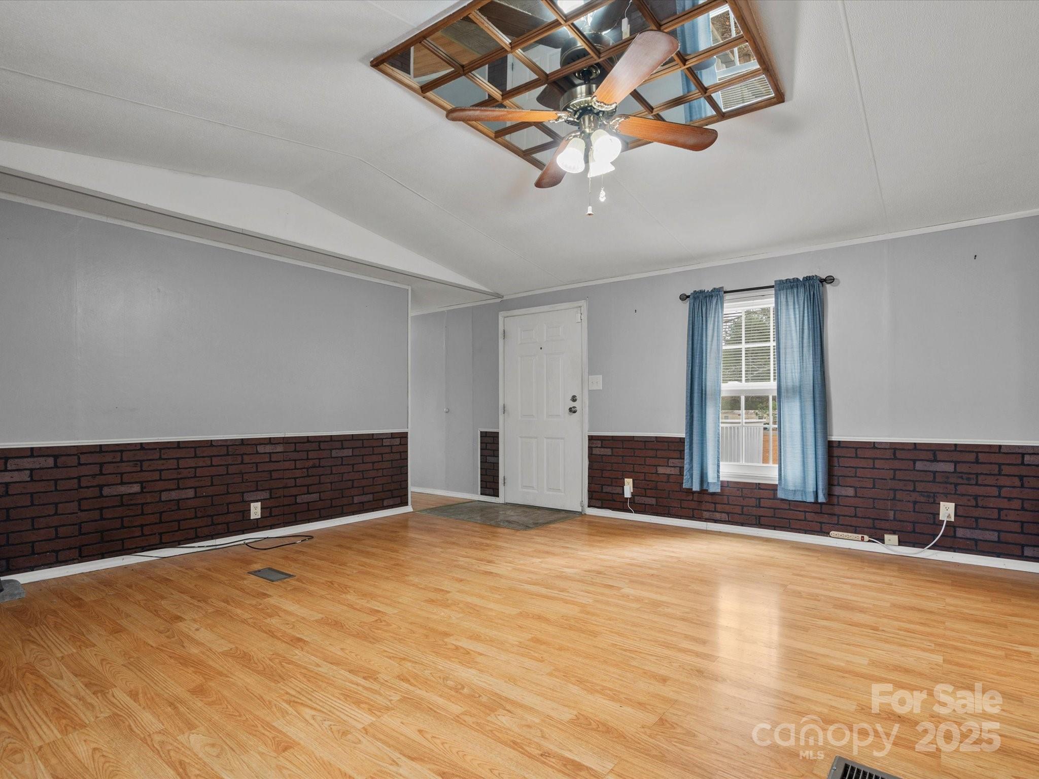 3231 Rocky Ridge Road Wallace, SC 29596 - Photo 3 of 35 a view of a livingroom with wooden floor and a ceiling fan