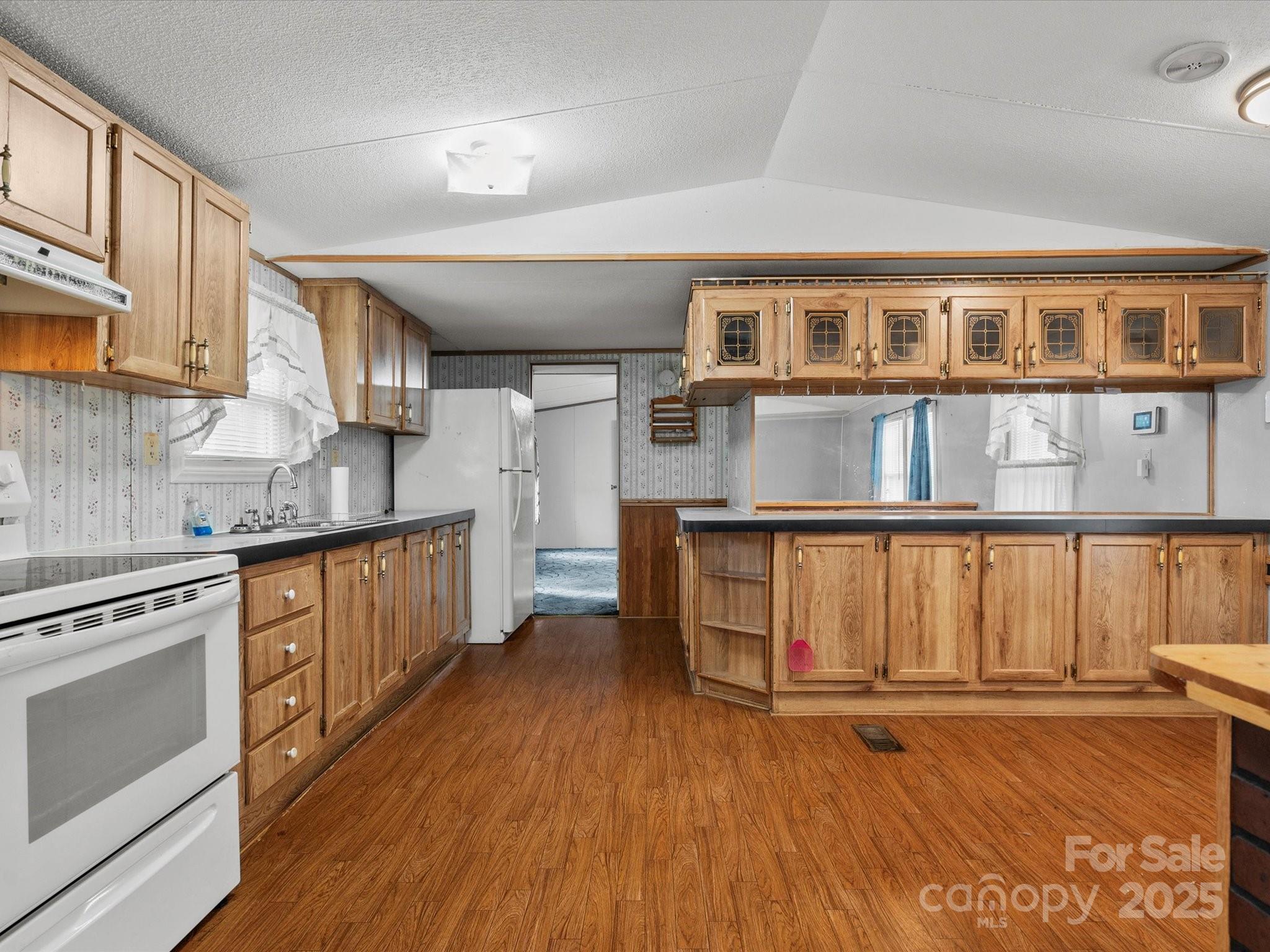 3231 Rocky Ridge Road Wallace, SC 29596 - Photo 5 of 35 a kitchen with stainless steel appliances granite countertop a stove top oven a sink dishwasher and cabinets with wooden floor