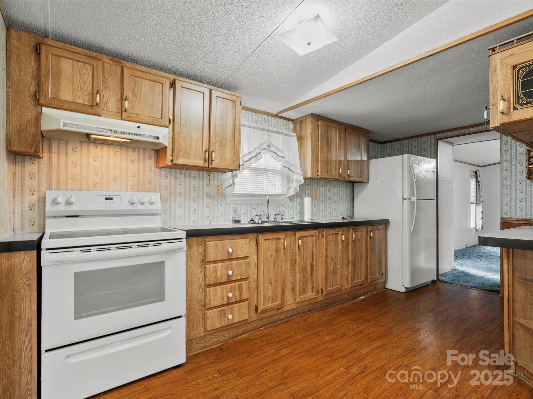 3231 Rocky Ridge Road Wallace, SC 29596 - Photo 7 of 35 a kitchen with stainless steel appliances granite countertop a stove a refrigerator and cabinets