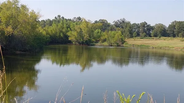 a view of a lake with houses in the back
