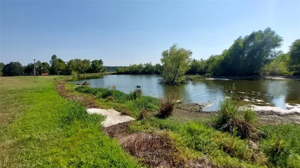 a view of a lake with houses in the back