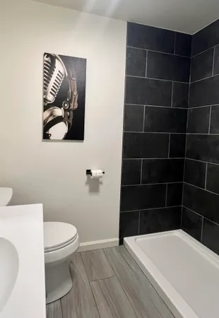 a bathroom with a toilet and a shower