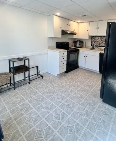 a kitchen with stainless steel appliances a stove a sink and a refrigerator