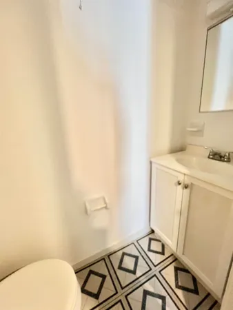 a bathroom with a sink toilet and mirror