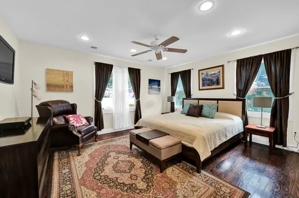 a bedroom with a bed mirror and window