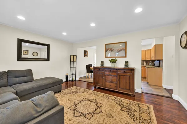 a living room with furniture window and wooden floor