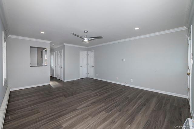 184 Hallock Road, Unit 6B1 Lake Grove, NY 11755 - Photo 4 of 8 a view of an empty room with wooden floor and a ceiling fan