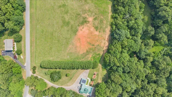 a view of a big yard with lots of green space