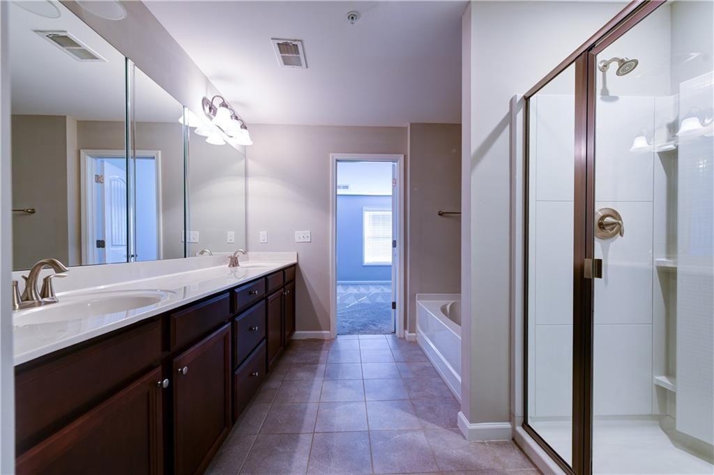 1226 Fischer Trace Cumming, GA 30041 - Photo 15 of 24 a bathroom with a double vanity sink and a mirror