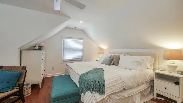 a bedroom with a bed and a chair