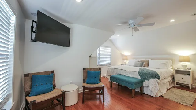 a living room with furniture a flat screen tv and a window