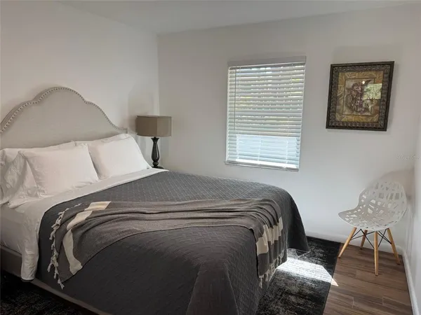 a bed sitting in a bedroom next to a window