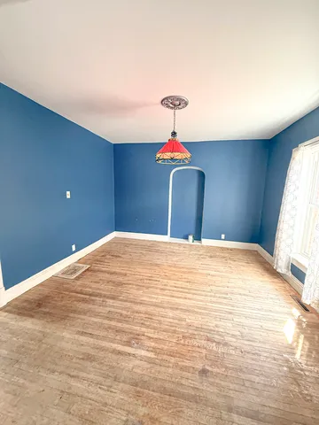 a view of a room with wooden floor and glass window