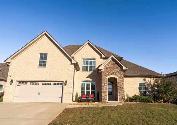 a front view of a house with wooden fence